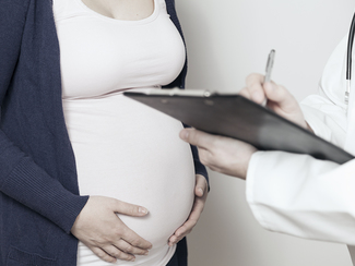 Pregnant women in consultation with a doctor