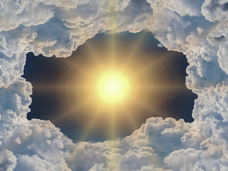 Sun in the sky, surrounded by clouds