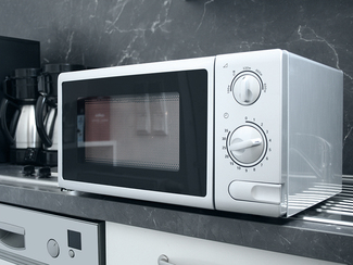 woman in the kitchen operatin a microwave oven